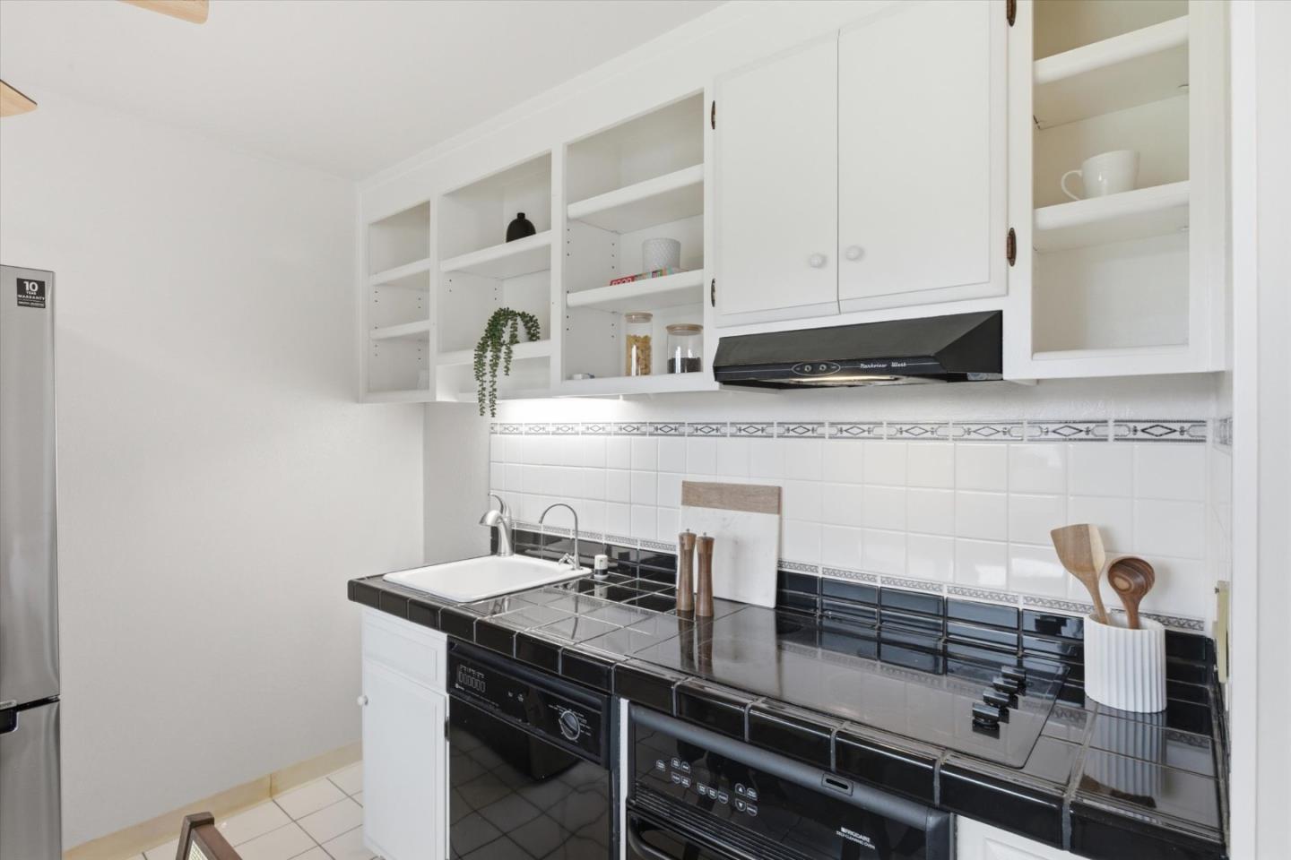 255 South Rengstorff Avenue, Unit 58 Mountain View, CA 94040 - Photo 12 of 27 a kitchen with granite countertop a sink and cabinets