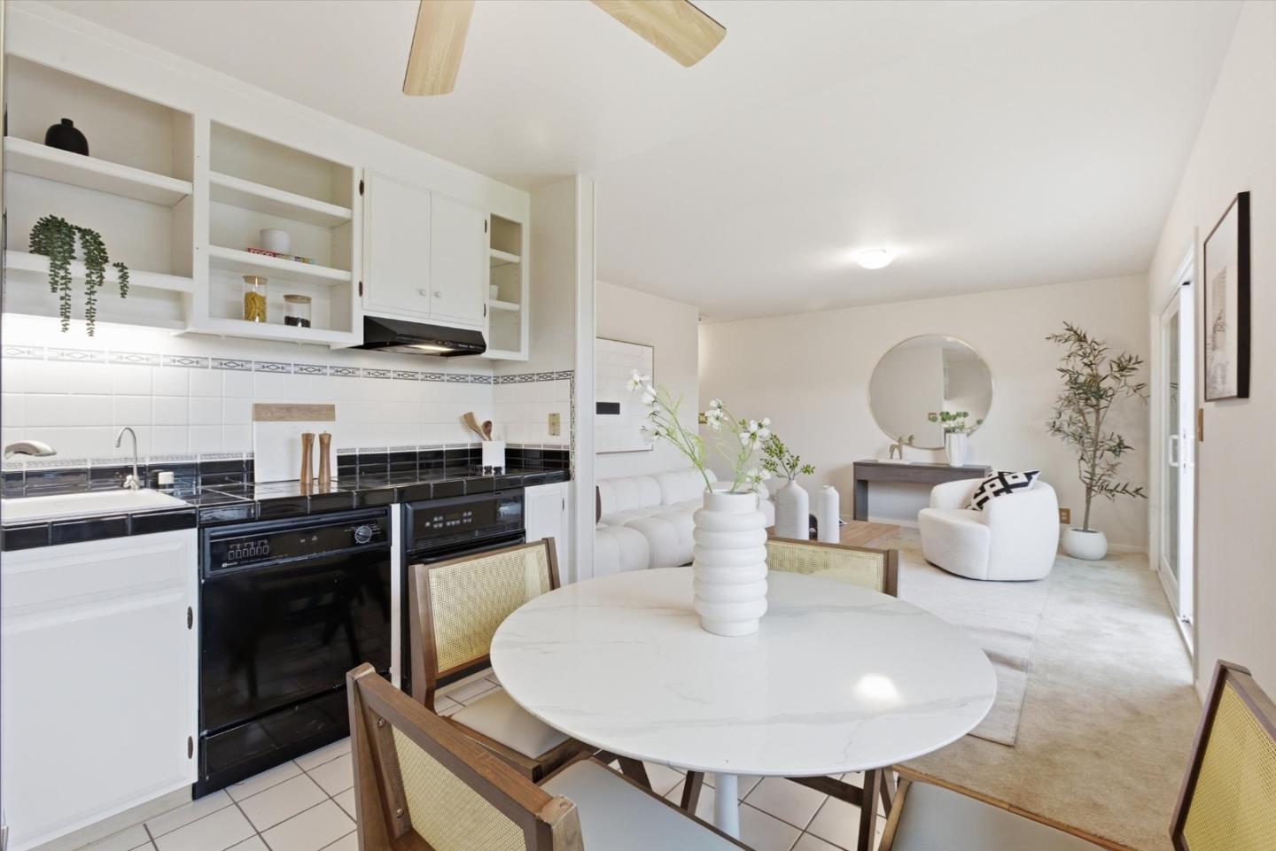 255 South Rengstorff Avenue, Unit 58 Mountain View, CA 94040 - Photo 14 of 27 a kitchen with stainless steel appliances a table and chairs