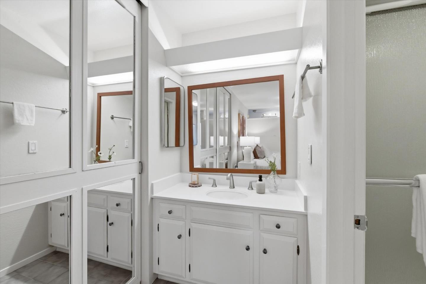 255 South Rengstorff Avenue, Unit 58 Mountain View, CA 94040 - Photo 20 of 27 a bathroom with a double vanity sink and mirror