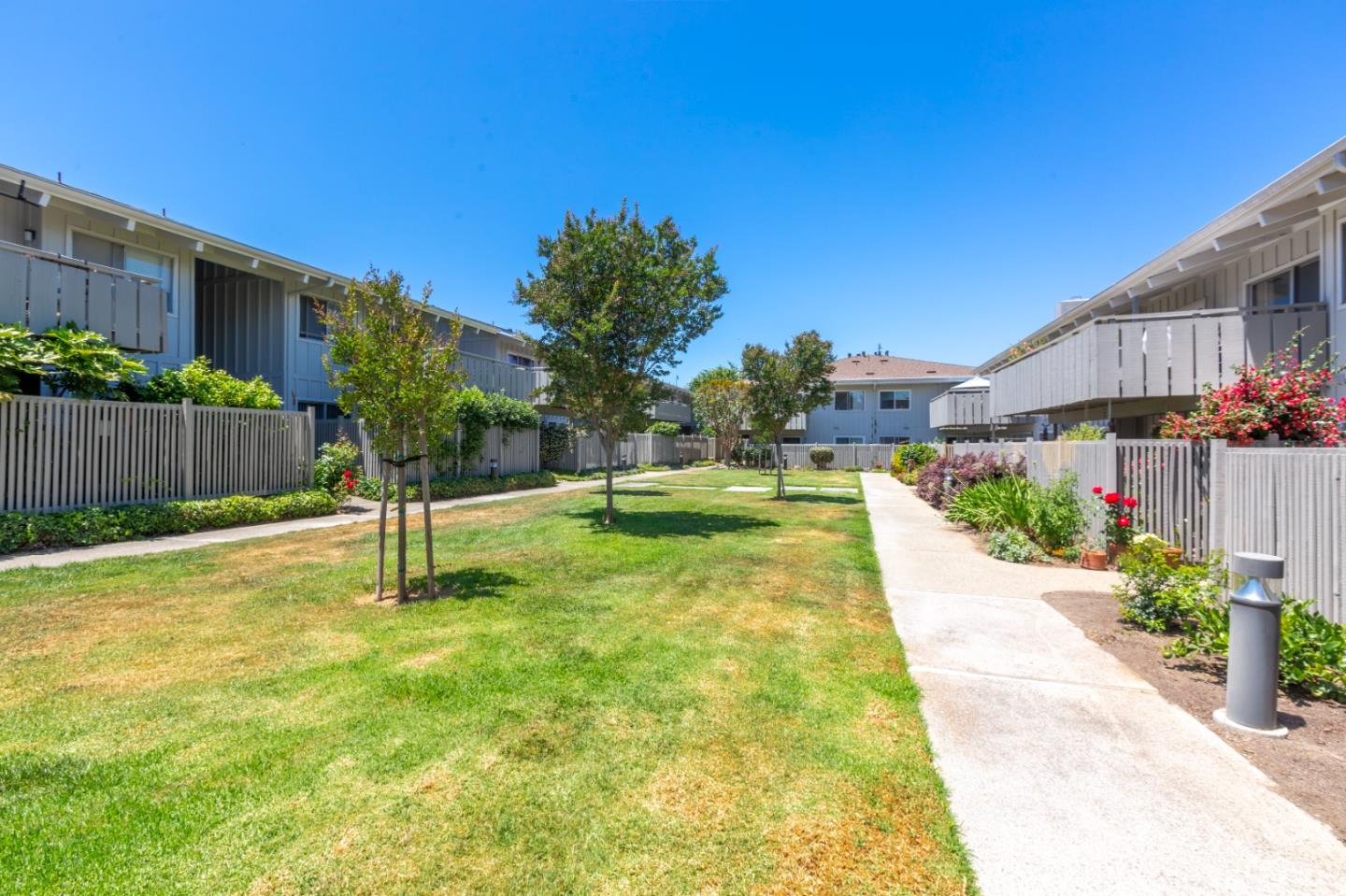 255 South Rengstorff Avenue, Unit 58 Mountain View, CA 94040 - Photo 23 of 27 a swimming pool with a wooden fence
