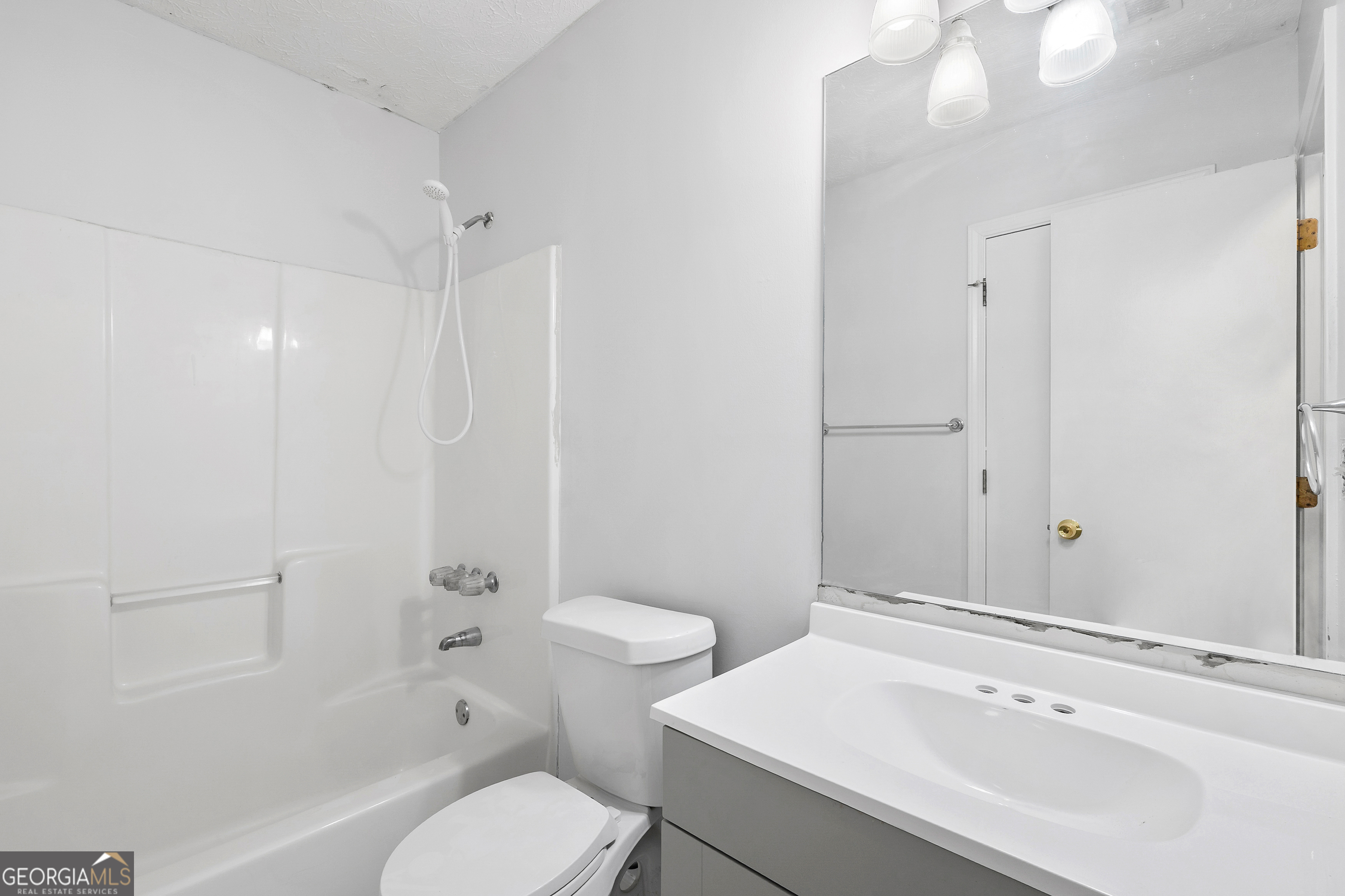 1328 Foxvale Drive Hampton, GA 30228 - Photo 24 of 27 a bathroom with a sink toilet vanity and shower