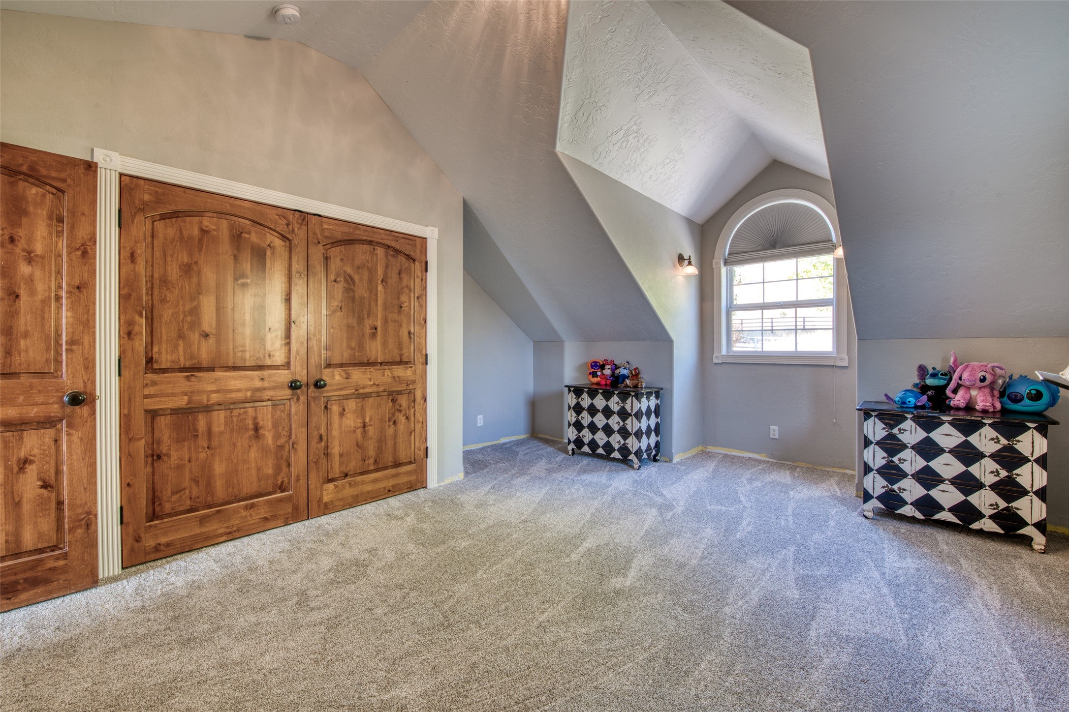 16374 Folsom Road Florence, MT 59833 - Photo 80 of 98 Bonus room with vaulted ceiling, carpet, and a textured ceiling