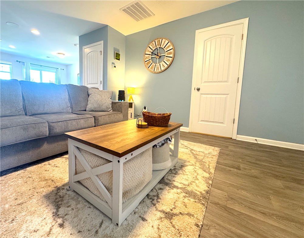 143 Adger Road Pendleton, SC 29670 - Photo 10 of 30 Smooth wood-look flooring and crisp white trim enhance this inviting open-concept living area.