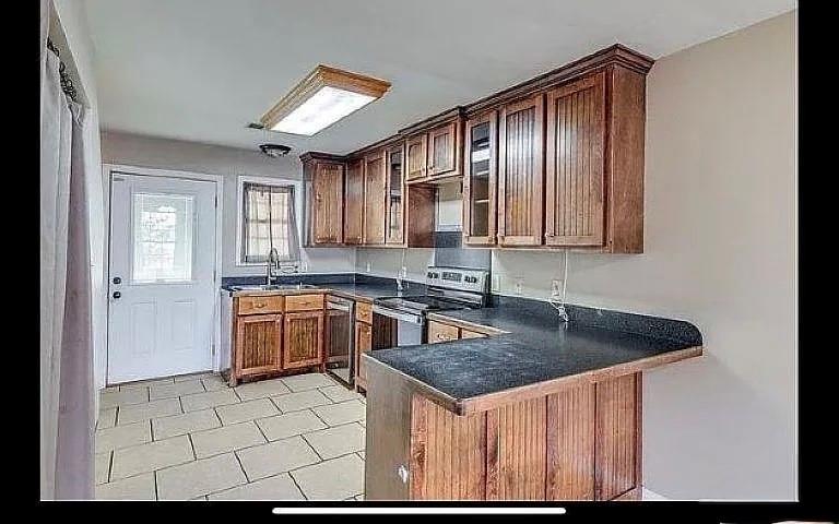1401 Olin Hills Road Farmerville, LA 71241 - Photo 11 of 18 a kitchen that has a sink cabinets counter space and appliances