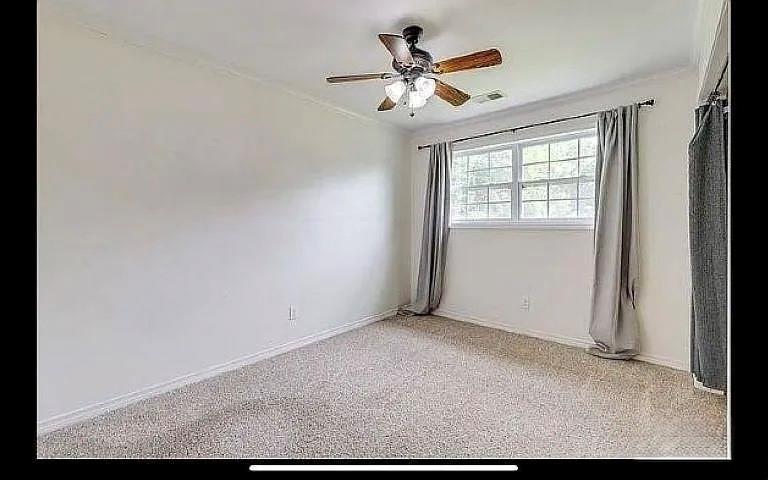 1401 Olin Hills Road Farmerville, LA 71241 - Photo 16 of 18 an empty room with a window and a fan