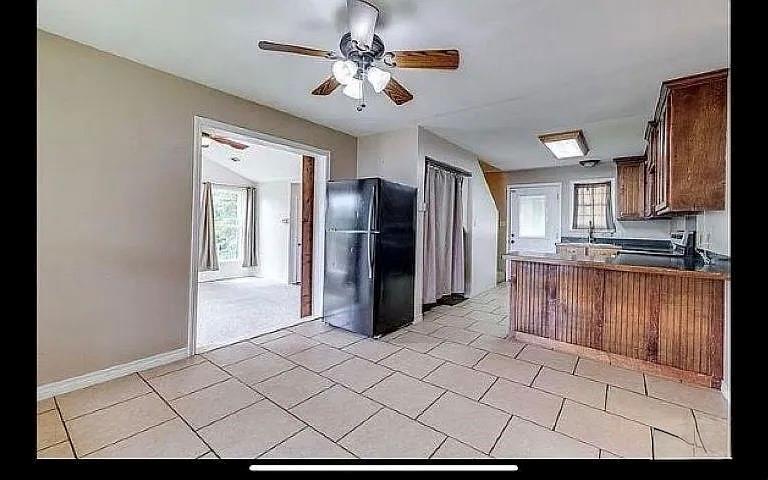 1401 Olin Hills Road Farmerville, LA 71241 - Photo 10 of 18 a kitchen with a refrigerator a sink and cabinets