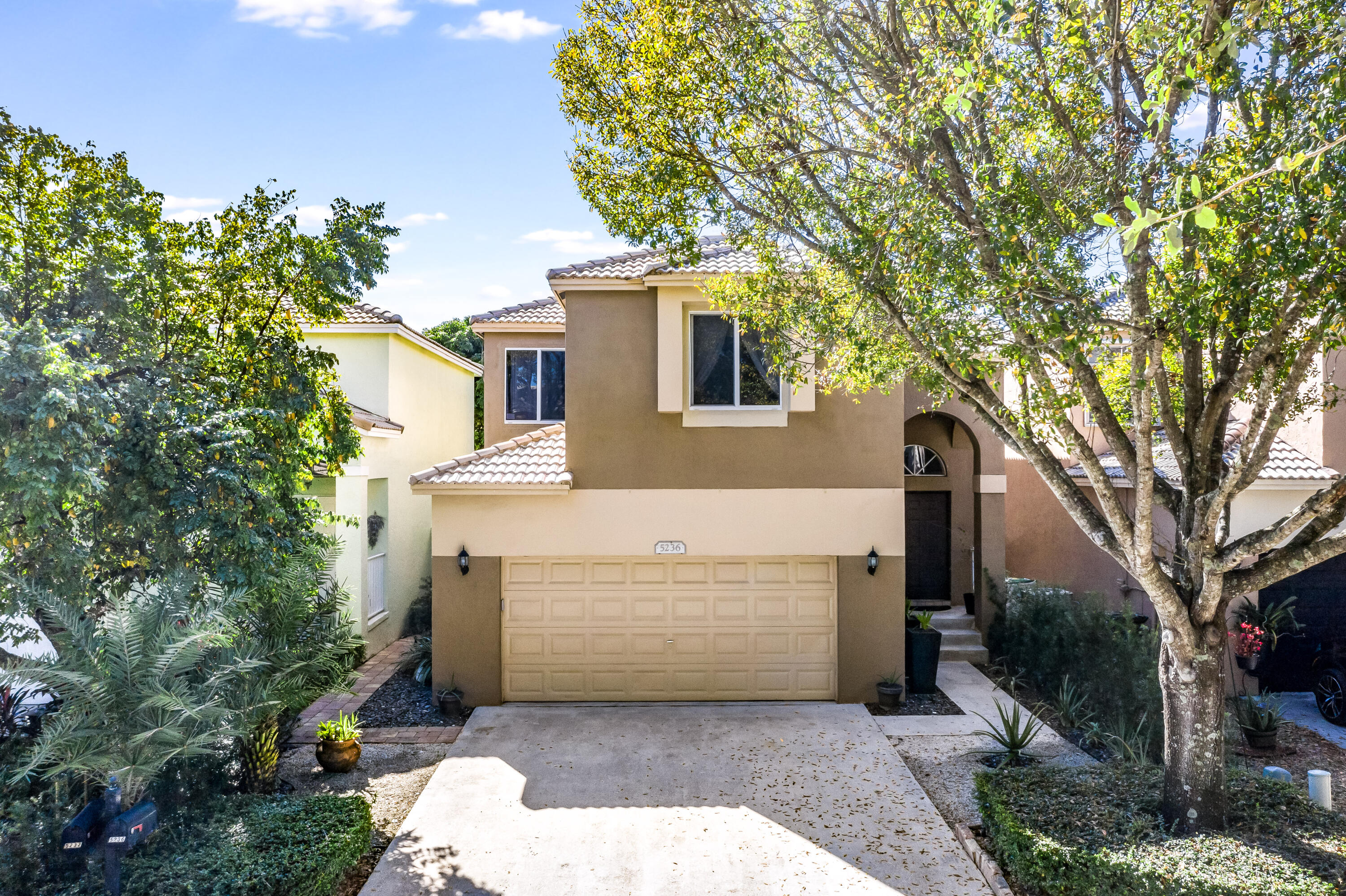 5236 Eagle Cay Way Coconut Creek, FL 33073 - Photo 1 of 33 a front view of a house with a garden