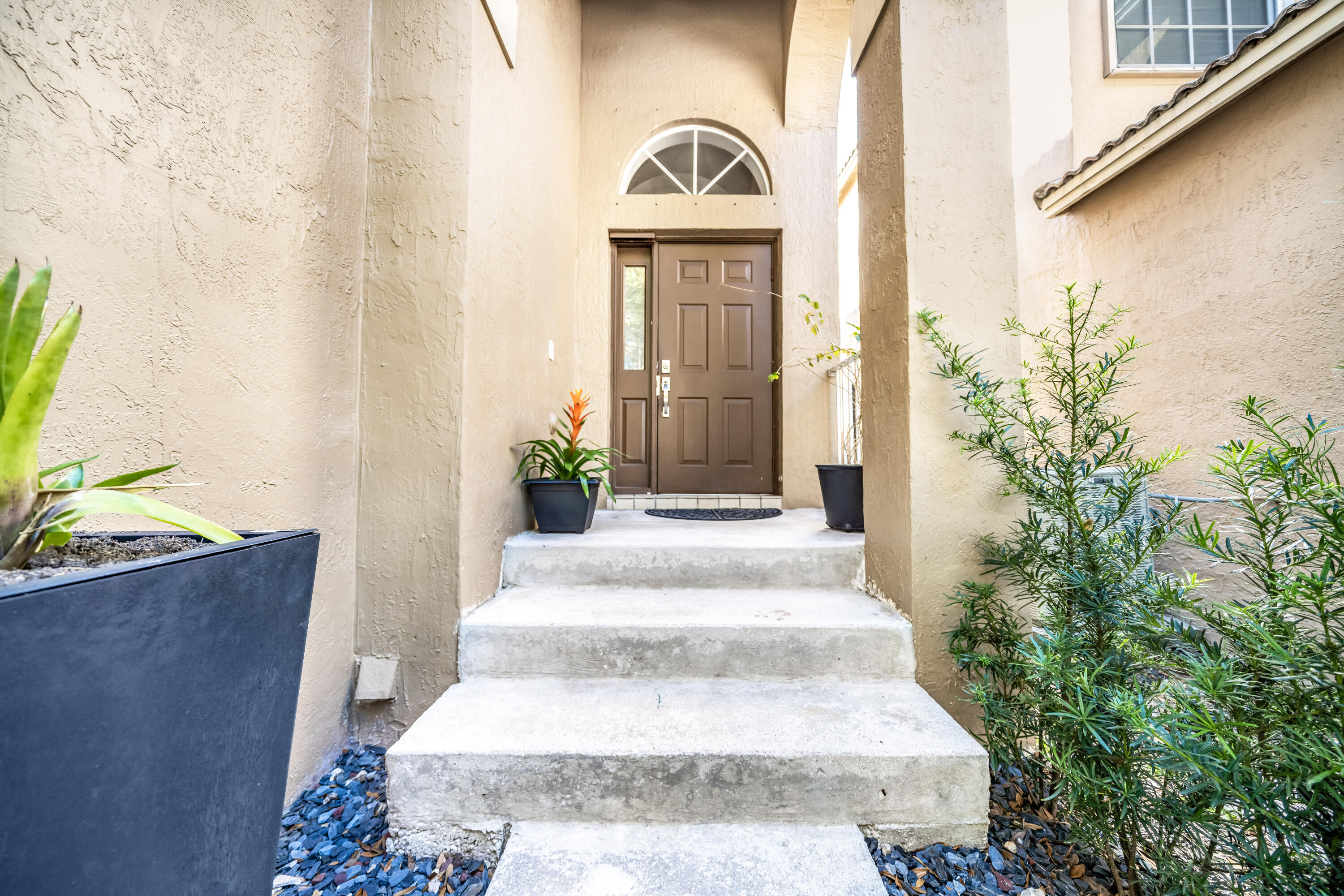 5236 Eagle Cay Way Coconut Creek, FL 33073 - Photo 25 of 33 a view of a brick house with potted plants