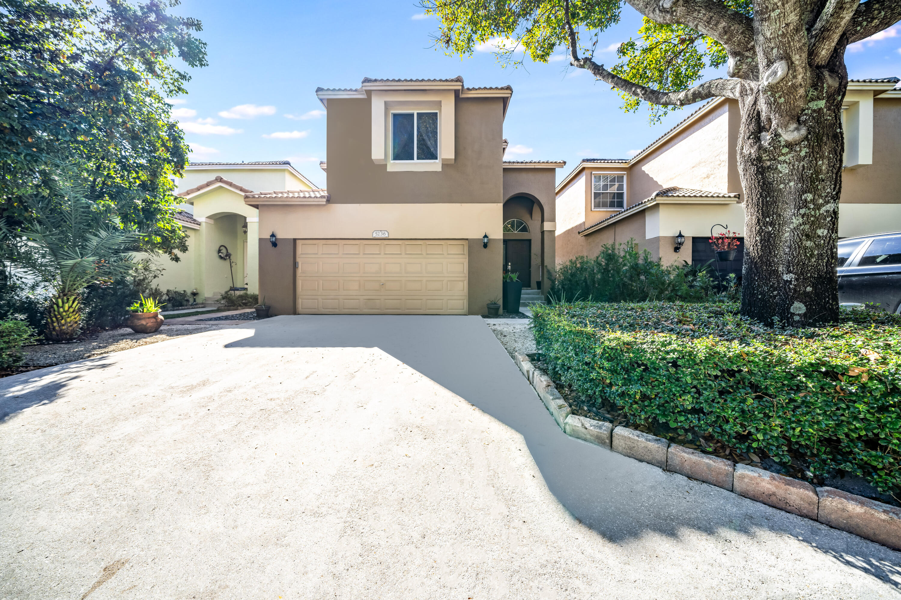 5236 Eagle Cay Way Coconut Creek, FL 33073 - Photo 26 of 33 a front view of a house with a yard and garage