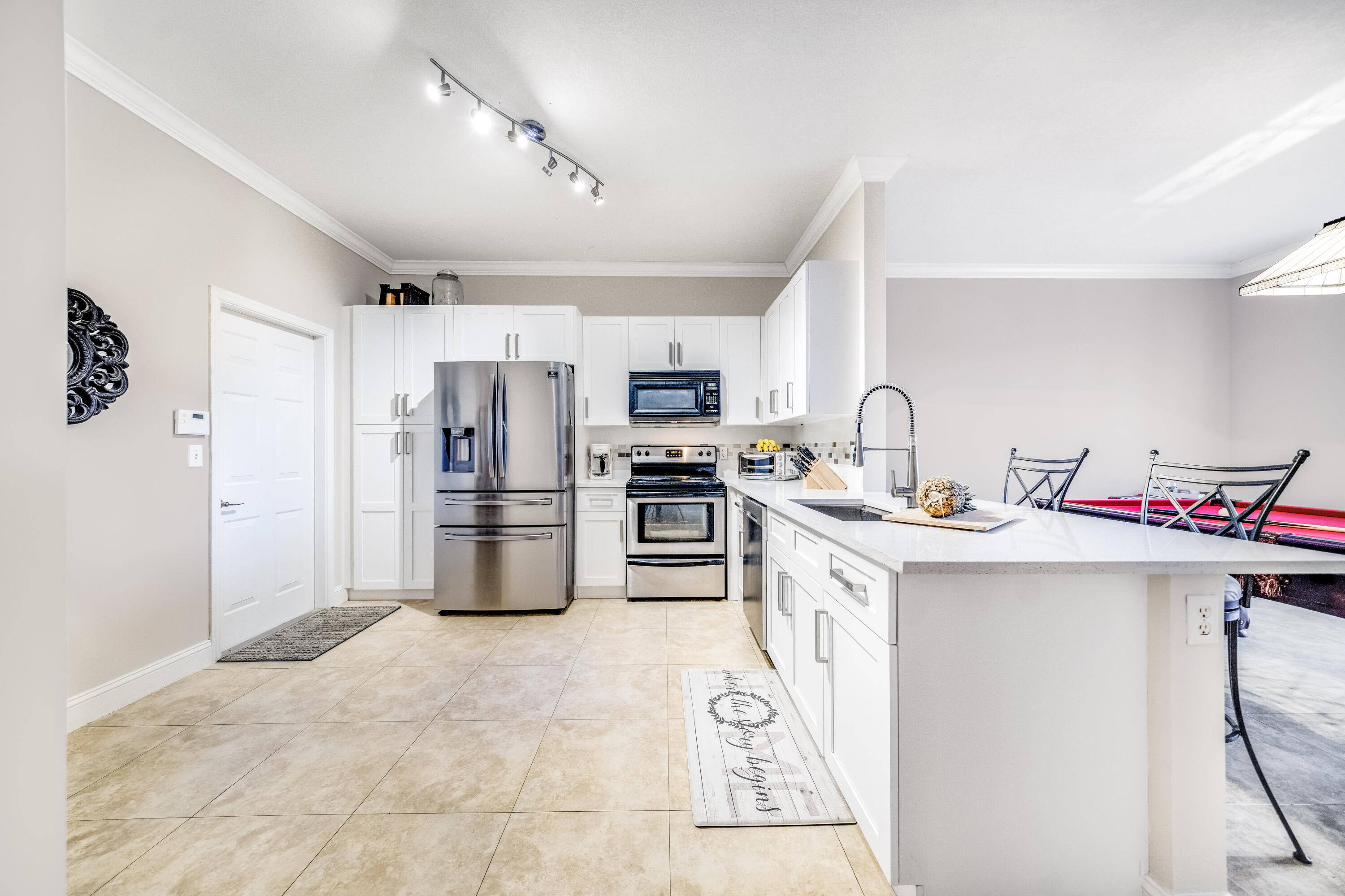5236 Eagle Cay Way Coconut Creek, FL 33073 - Photo 9 of 33 a kitchen that has a lot of cabinets and refrigerator