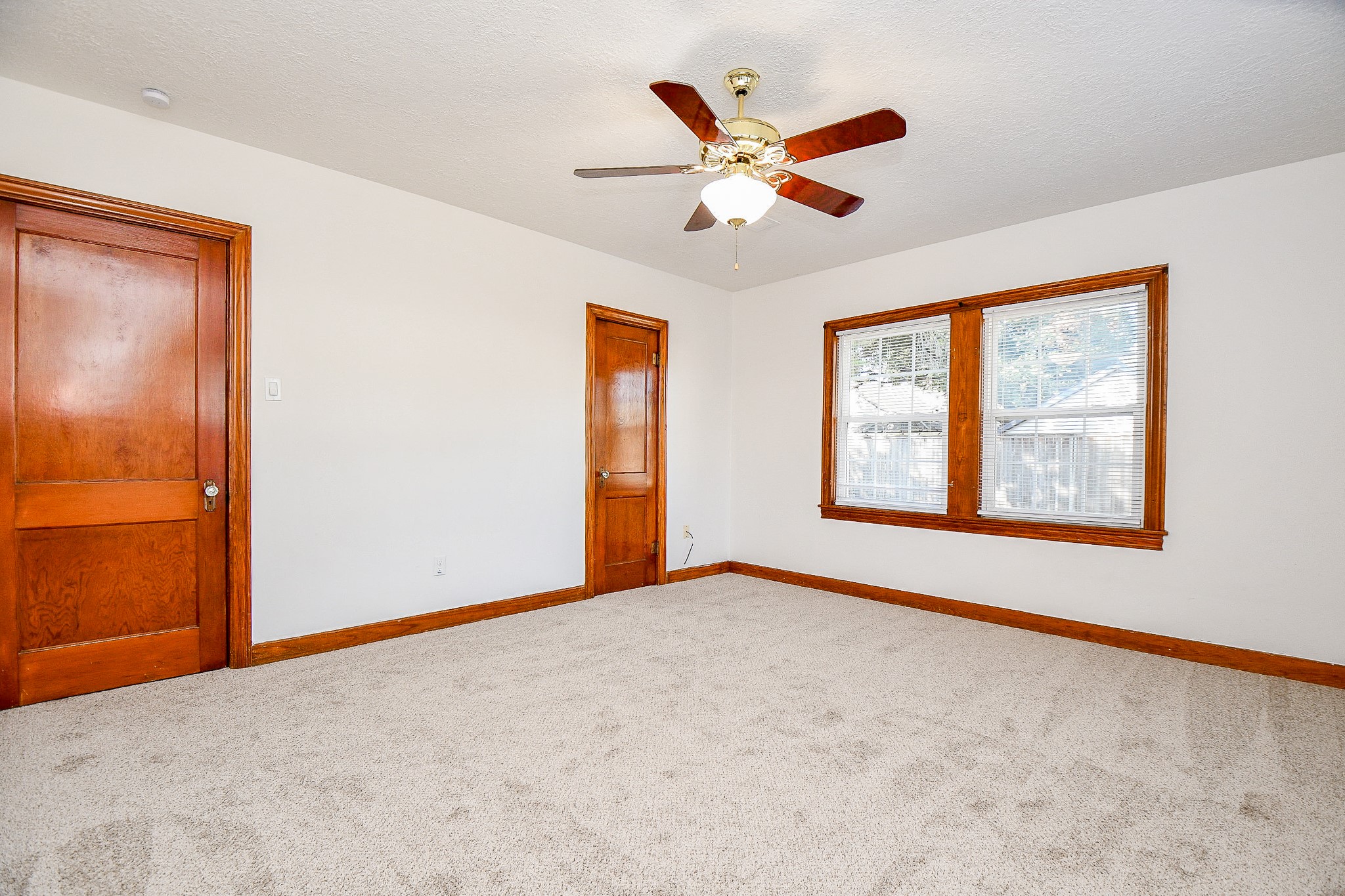 609 Milwaukee Street Houston, TX 77009 - Photo 12 of 32 an empty room with windows and fan