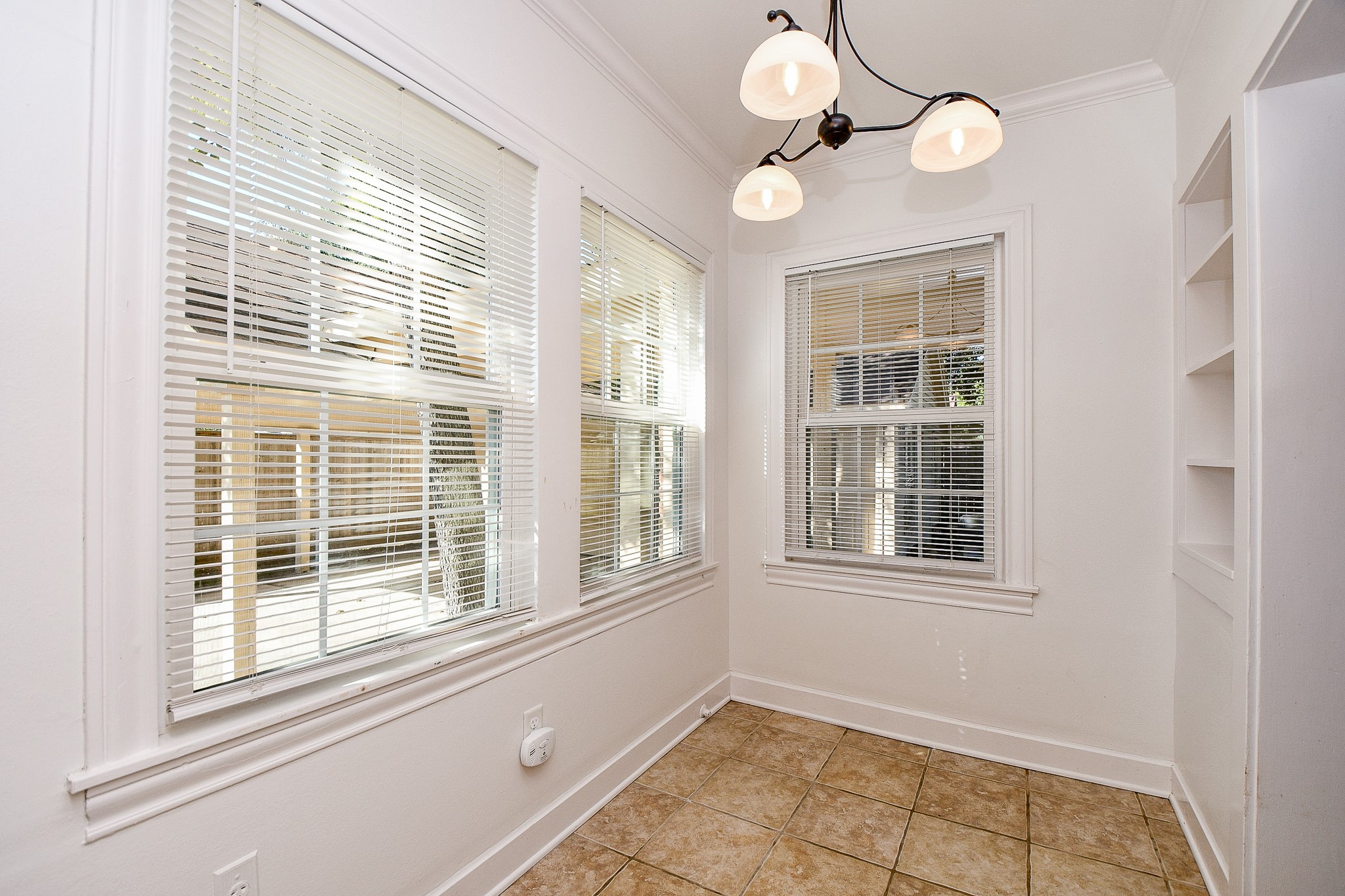 609 Milwaukee Street Houston, TX 77009 - Photo 16 of 32 a view of an empty room with a window and chandelier