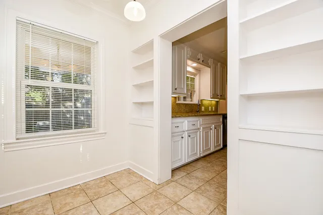 a kitchen with granite countertop a sink stove and cabinets