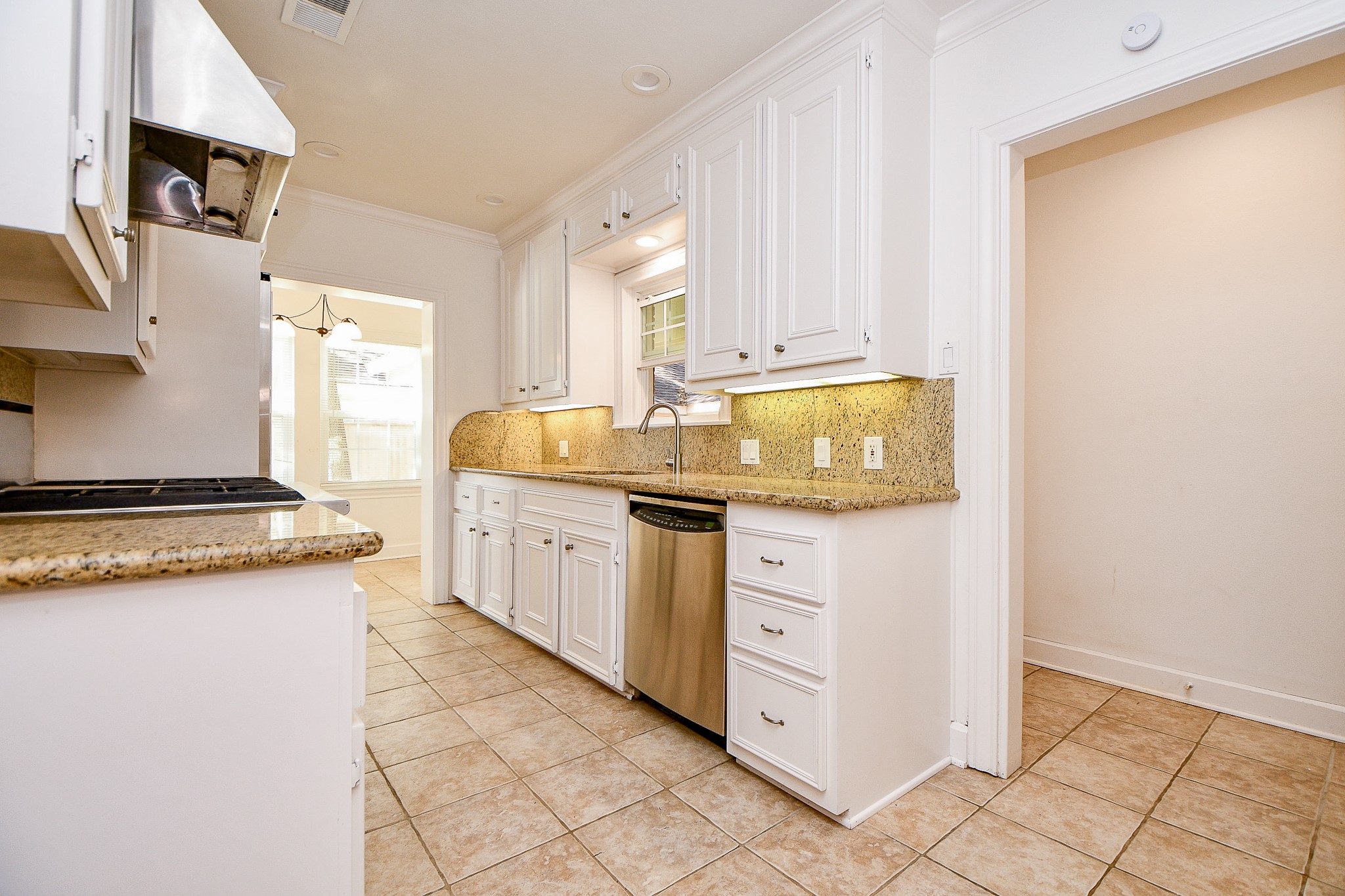 609 Milwaukee Street Houston, TX 77009 - Photo 25 of 32 a kitchen with granite countertop a sink stove and cabinets