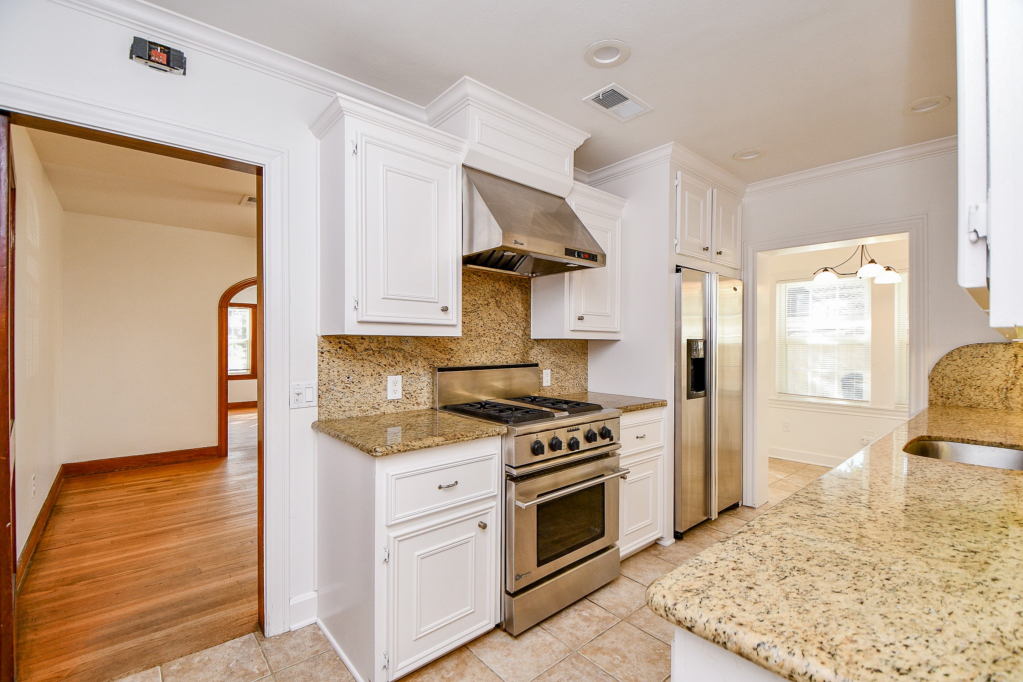 609 Milwaukee Street Houston, TX 77009 - Photo 26 of 32 a kitchen with a stove and a white refrigerator