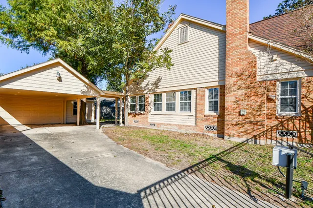 a front view of a house with a yard balcony