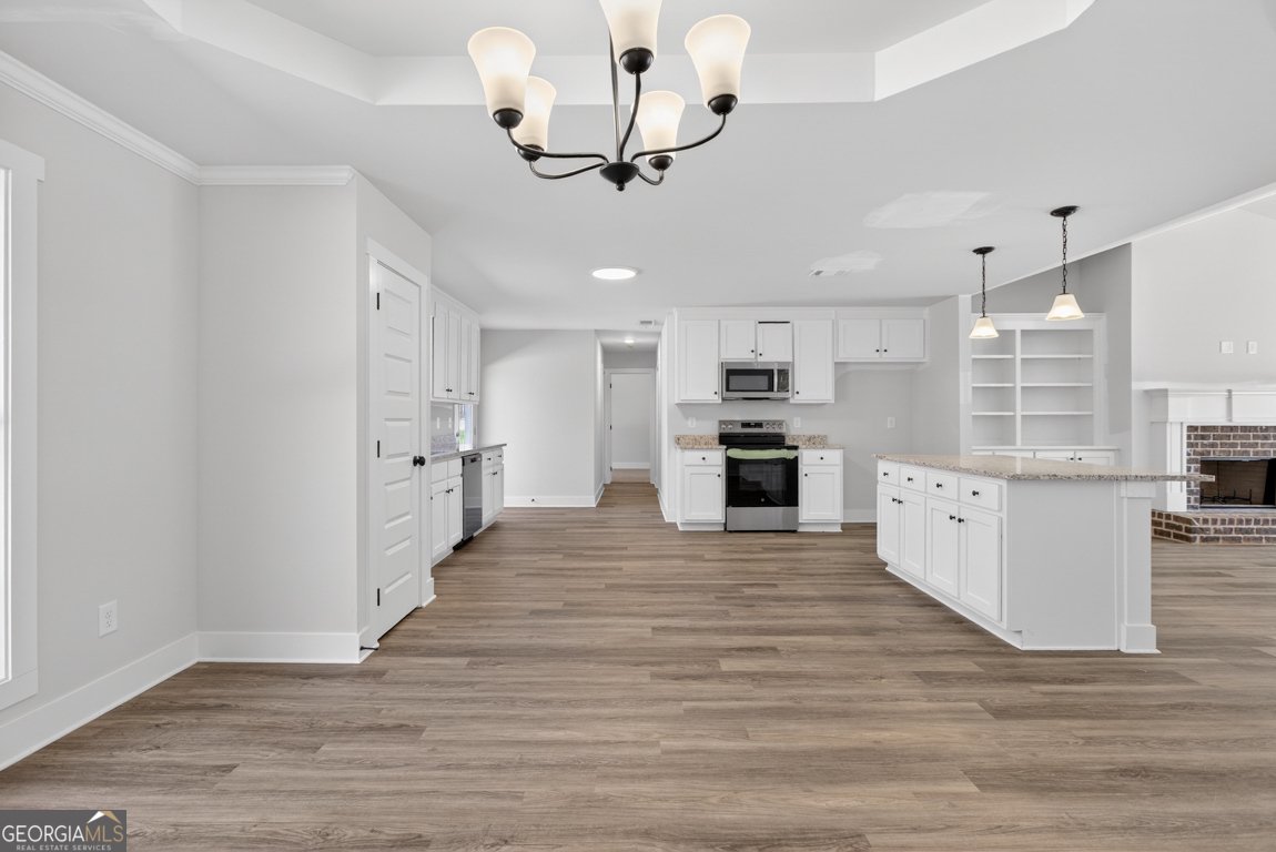 226 Airport Road, Unit 10 Canon, GA 30520 - Photo 17 of 43 a large kitchen with cabinets wooden floor and stainless steel appliances