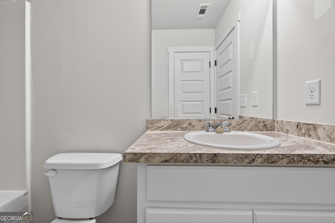 226 Airport Road, Unit 10 Canon, GA 30520 - Photo 31 of 43 a bathroom with a granite countertop toilet and a sink
