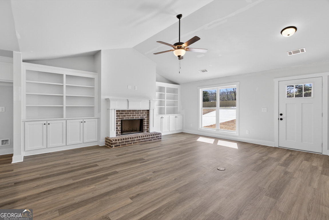 226 Airport Road, Unit 10 Canon, GA 30520 - Photo 6 of 43 a view of an empty room with a fireplace and a window