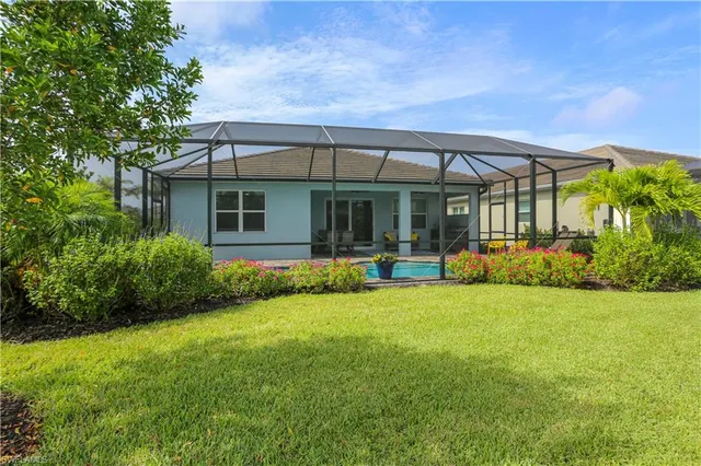 a view of a house with backyard porch and sitting area