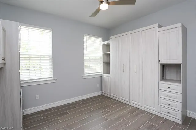 a view of an empty room with a window and closet