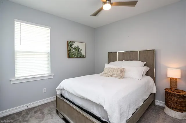 a large bed sitting in a bedroom next to a window