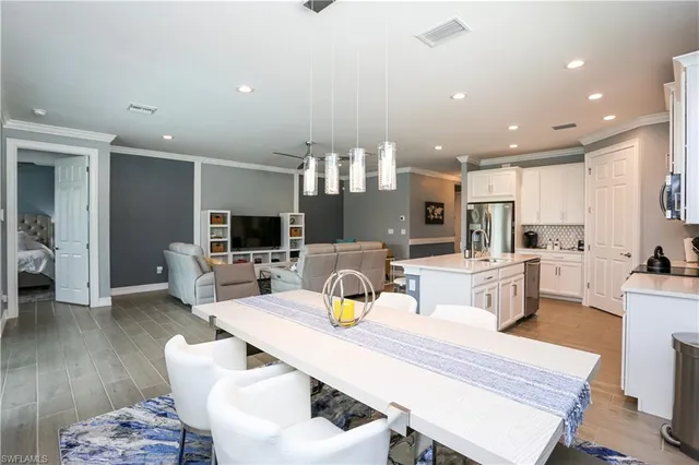 a kitchen with stainless steel appliances kitchen island granite countertop a sink and cabinets