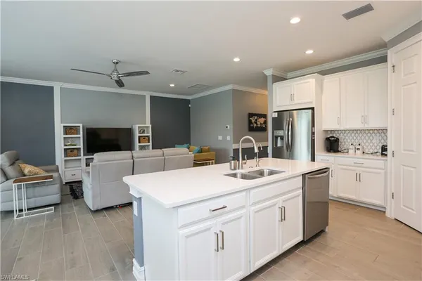 a kitchen with a sink and white cabinets