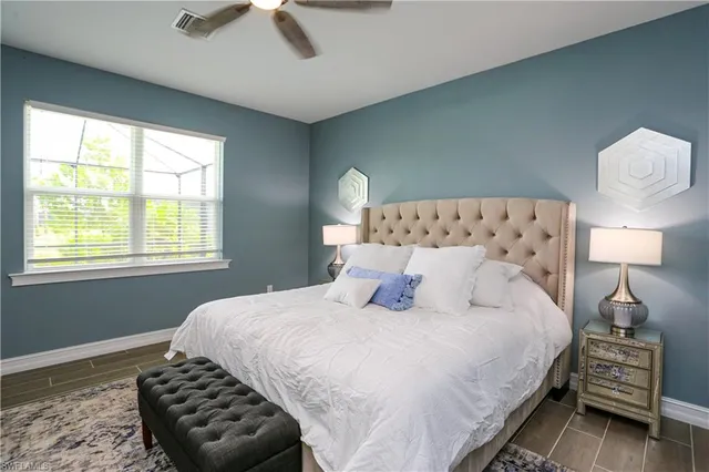 a bedroom with a bed and a lamp