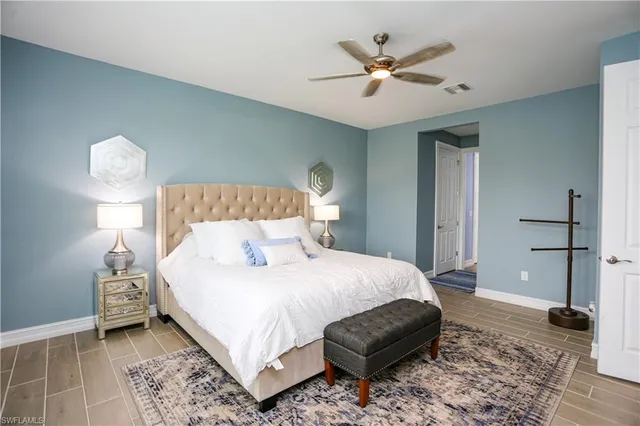 a bedroom with a bed and a ceiling fan