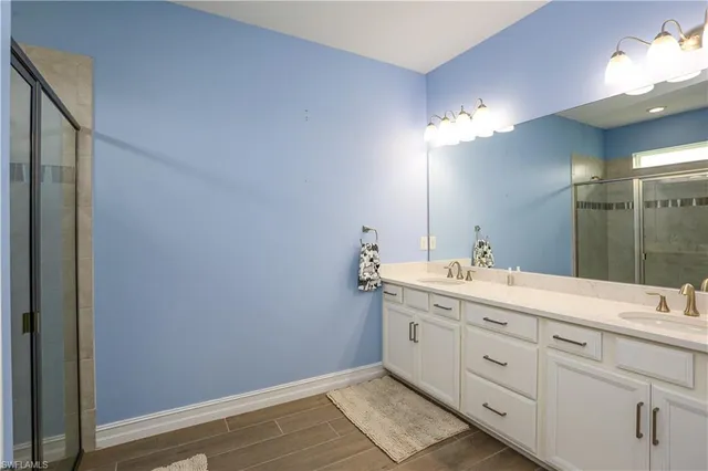 a bathroom with a double vanity sink and a mirror