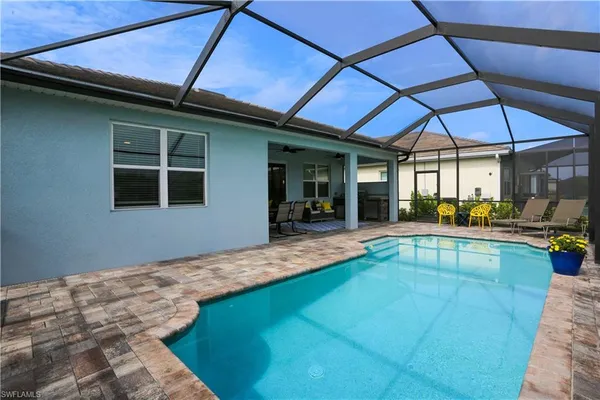 a view of swimming pool with outdoor seating
