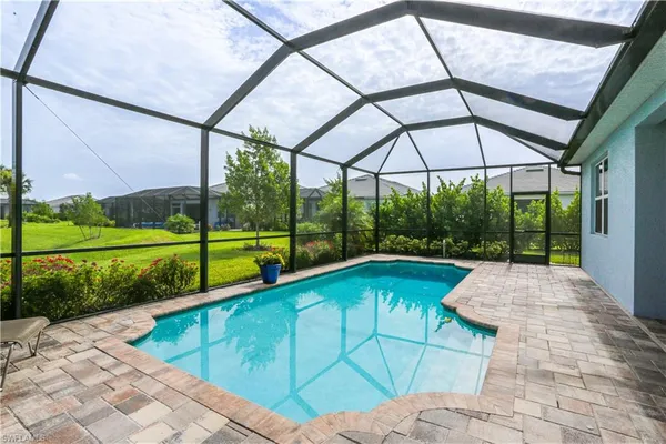 a view of a swimming pool with a yard