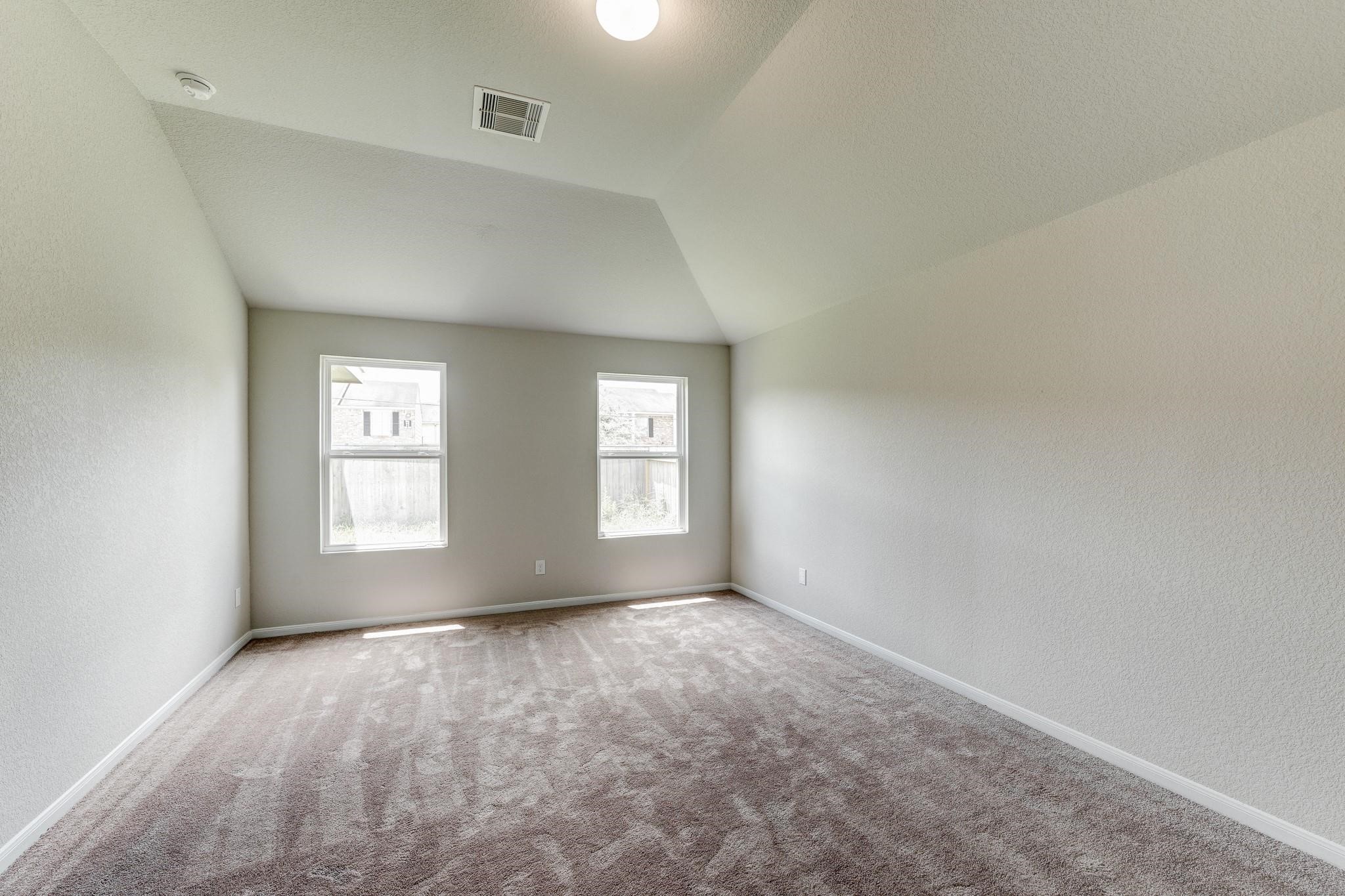 1015 Willowick Road Houston, TX 77090 - Photo 19 of 42 The spacious primary bedroom features elegant design and a walk-in closet for added convenience.