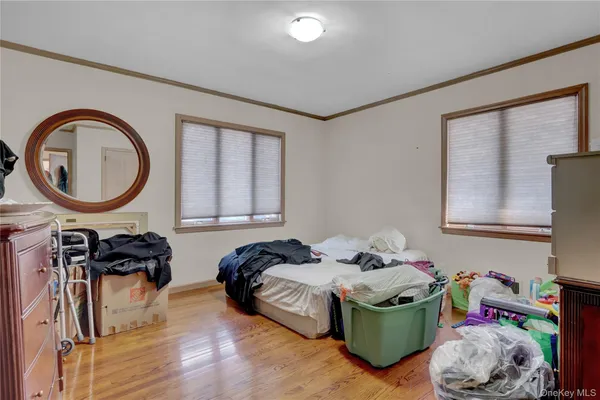 a bedroom with furniture and a mirror