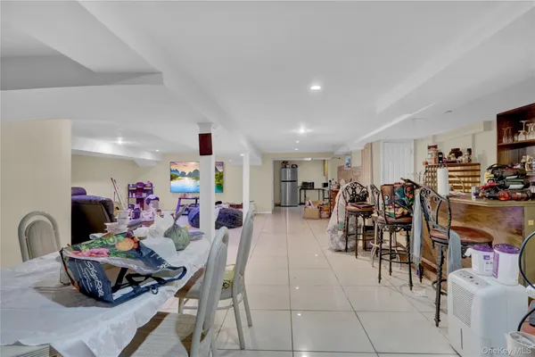 a very nice looking dining room with lots of furniture