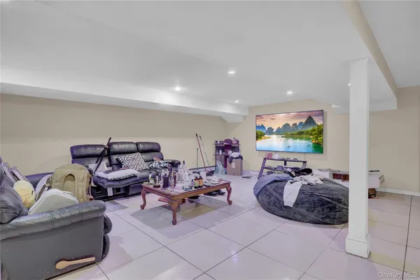a living room with furniture a air conditioner vent and a window
