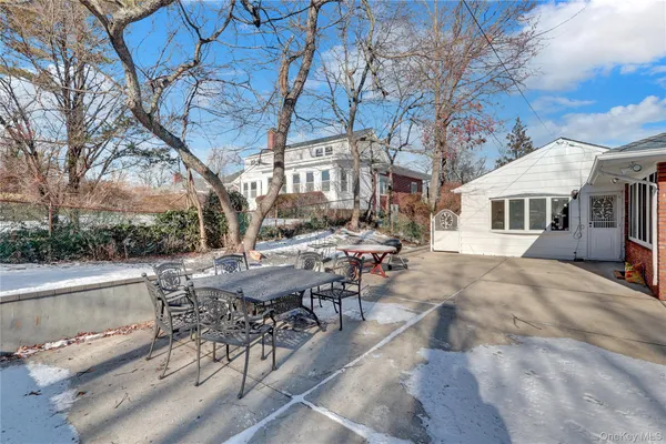 a view of a patio with table and chairs and couches
