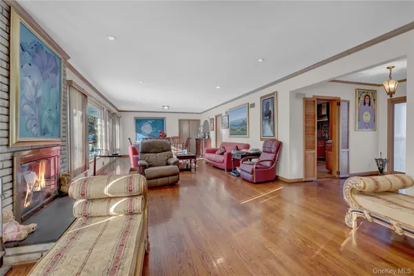 a living room with furniture large window and a fireplace