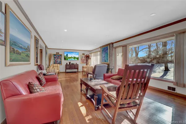 a dining room with furniture window and wooden floor
