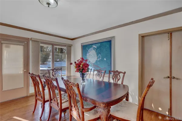 a view of a dining room with furniture and wooden floor