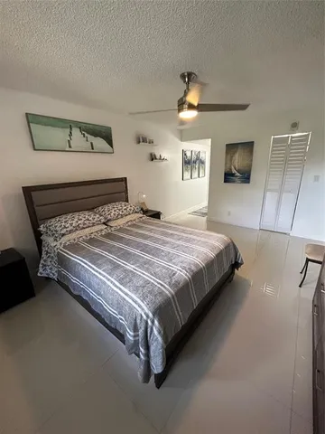 a bedroom with a bed and a lamp on table
