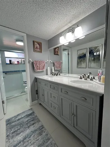 a bathroom with a double vanity sink and a mirror