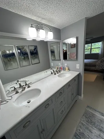 a bathroom with a double vanity sink and a mirror