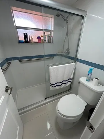 a bathroom with a toilet and a shower