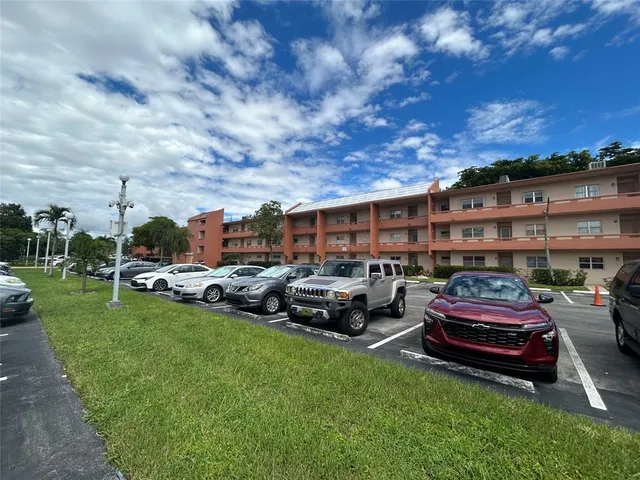 a couple of cars parked in front of a house