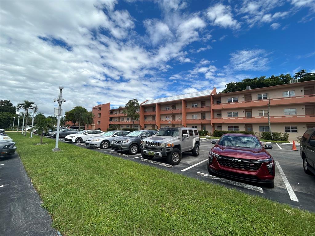 8818 West McNab Road, Unit 303 Tamarac, FL 33321 - Photo 2 of 23 a couple of cars parked in front of a house
