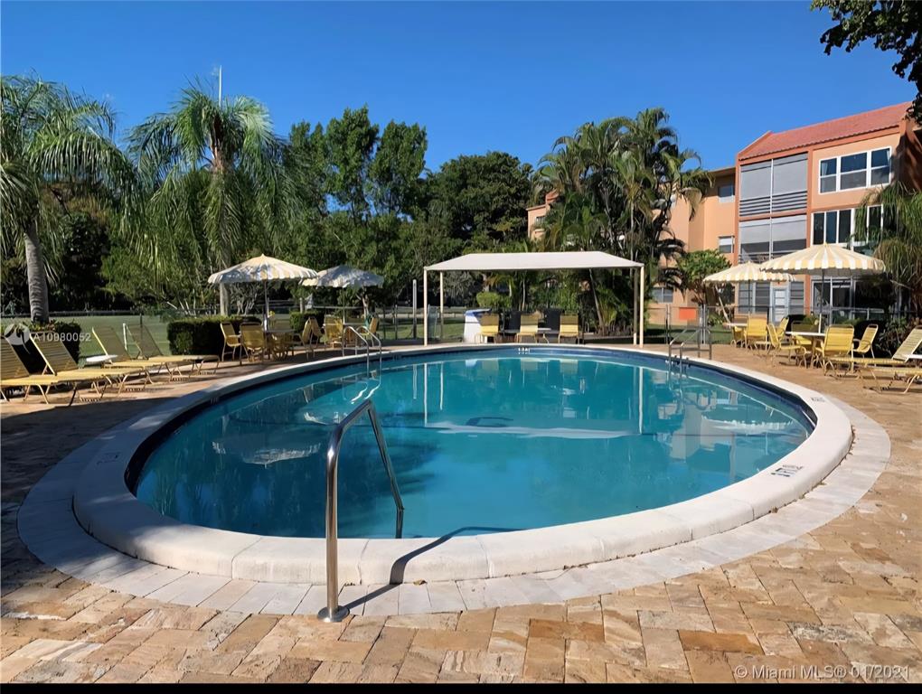 8818 West McNab Road, Unit 303 Tamarac, FL 33321 - Photo 22 of 23 a view of a swimming pool with a patio