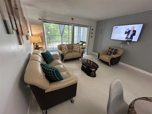 a living room with furniture rug and window