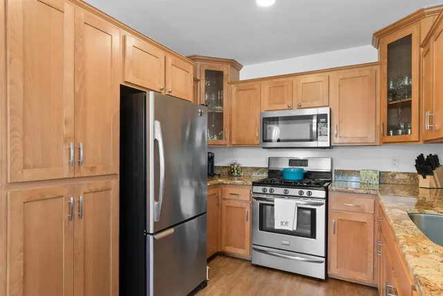 a kitchen with a refrigerator stove and microwave